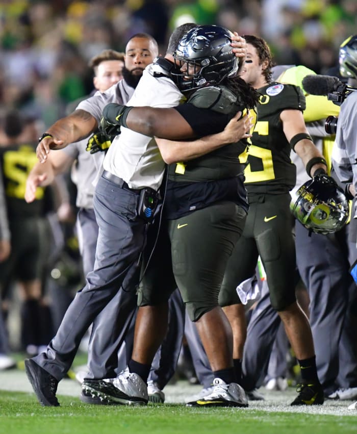 Jordon Scott celebrates winning the 2020 Rose Bowl with Oregon Ducks Head Coach Mario Cristobal.